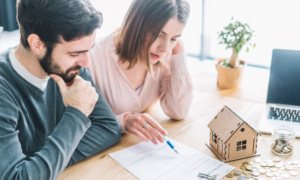 Couple Reviewing Checklist For Mortgages